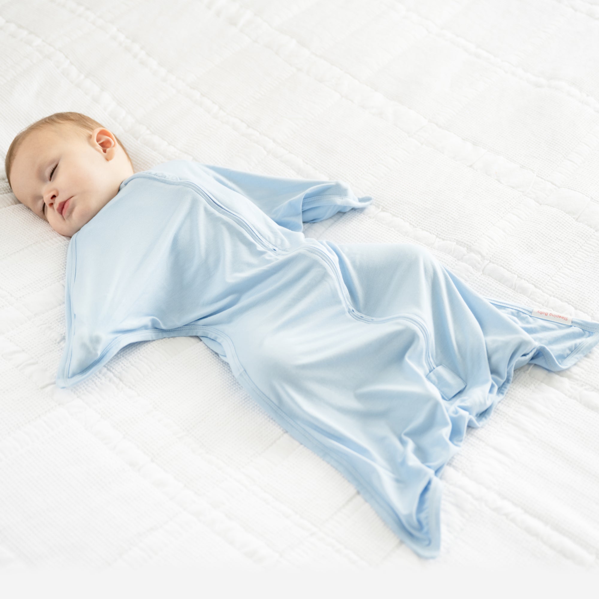 Baby wearing Sky Blue bamboo Zipadee-Zip swaddle