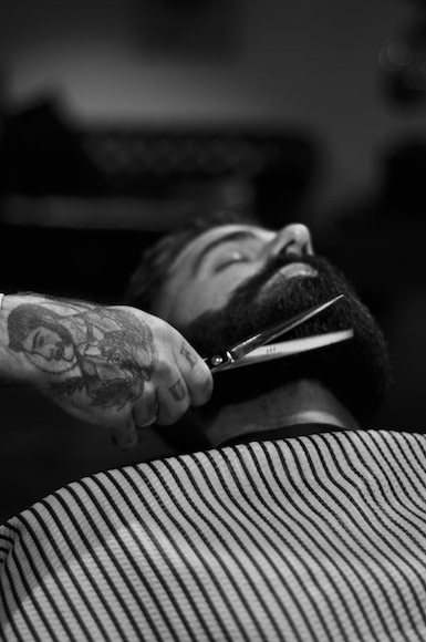 Can Your Boss Make You Shave Your Beard:grayscale photography of person holding scissor clipping man's beard