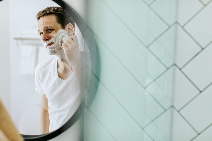 how long does shaving brush last:man shaving in front of mirror